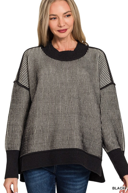 Exposed seam sweater for women in black with high-low hem – front view